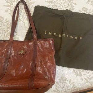 The Bridge Leather brown tote bag with gold logo.